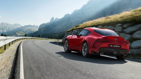 Toyota Supra driving along a road