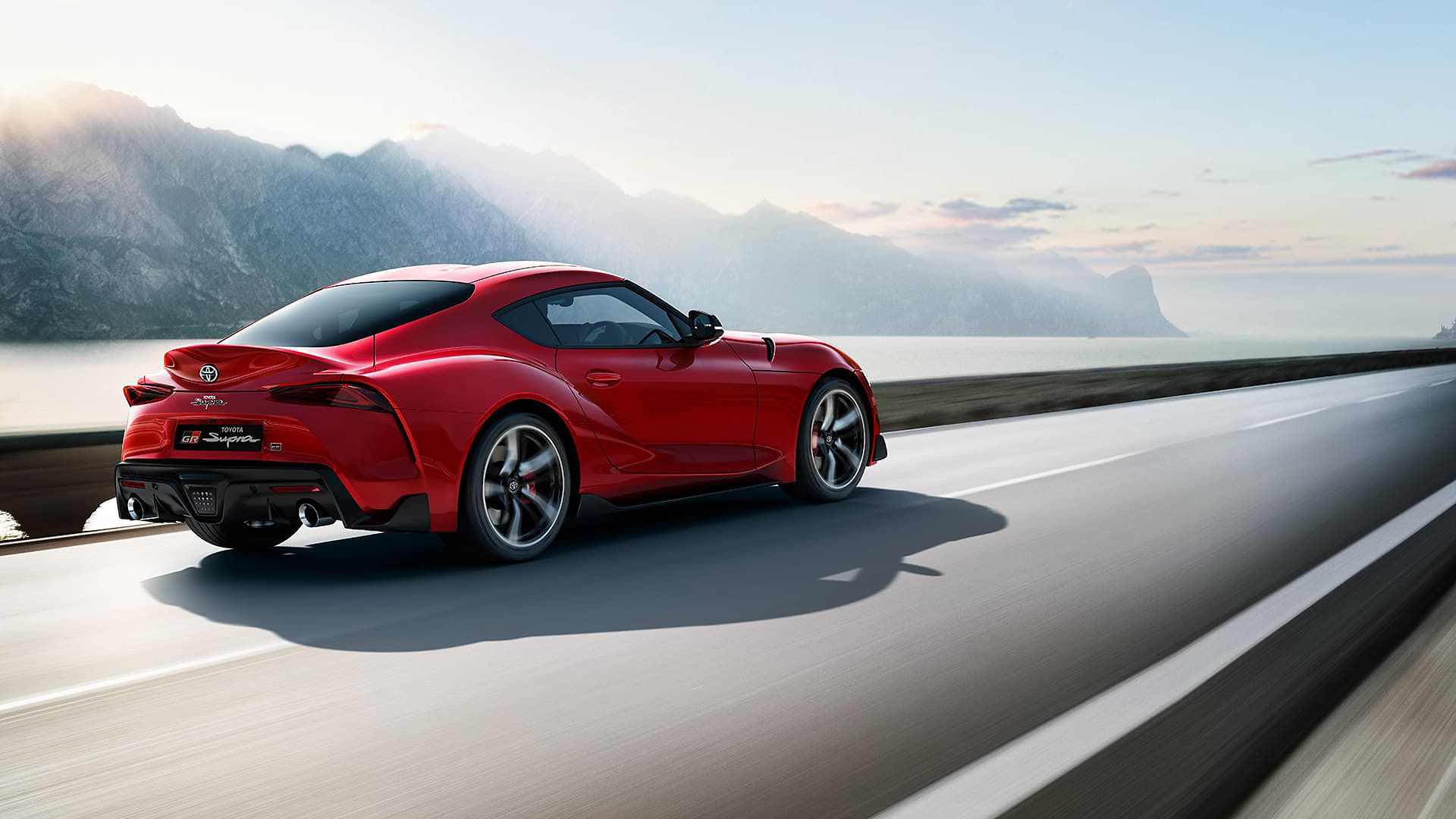 Toyota Supra driving along a road