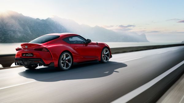 Toyota Supra driving along a road