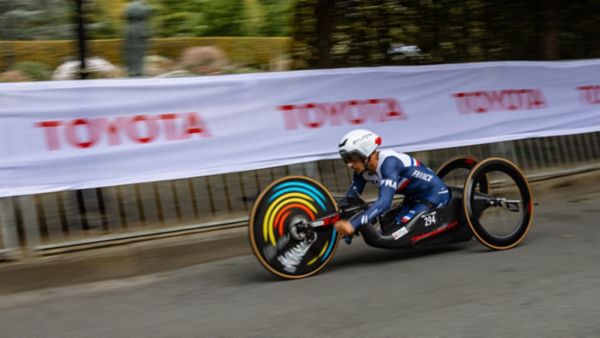 Akio Toyoda and Sir Philip Craven holding up a signed Worldwide Paralympic Partnership agreement