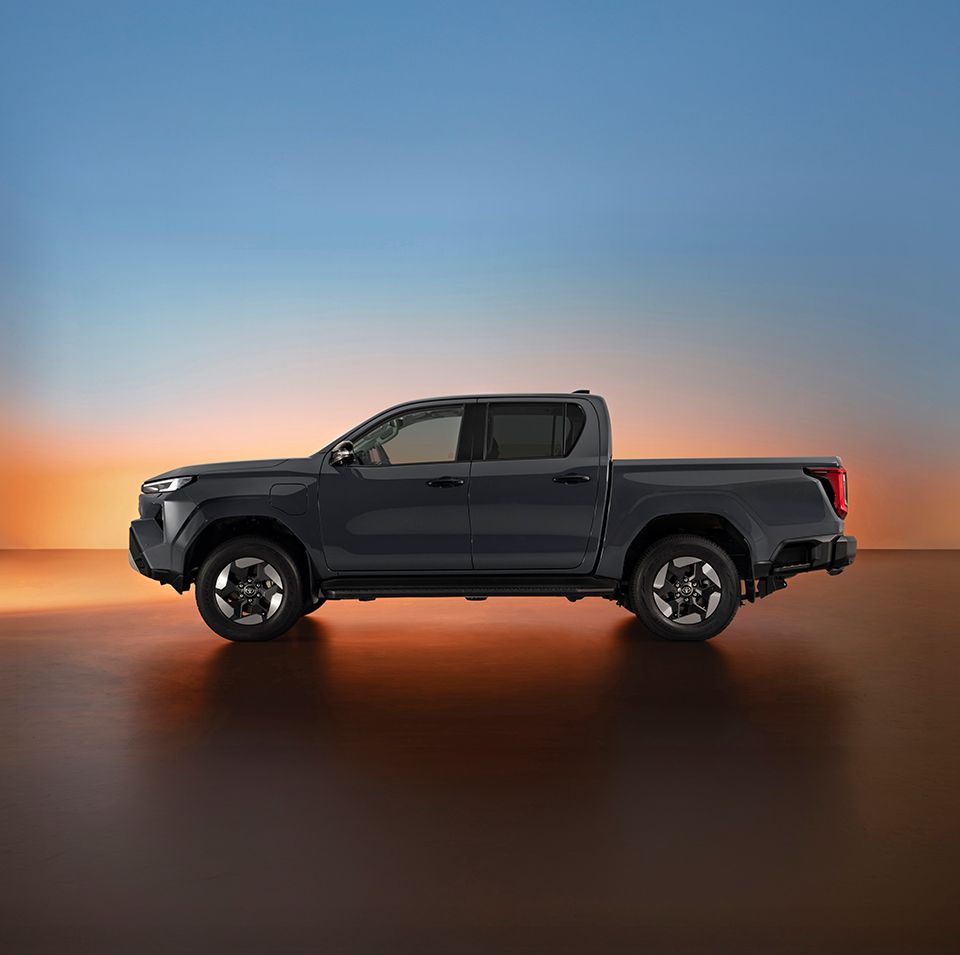 Zamglone zdjęcie Toyoty Hilux na plaży w świetle zachodzącego słońca