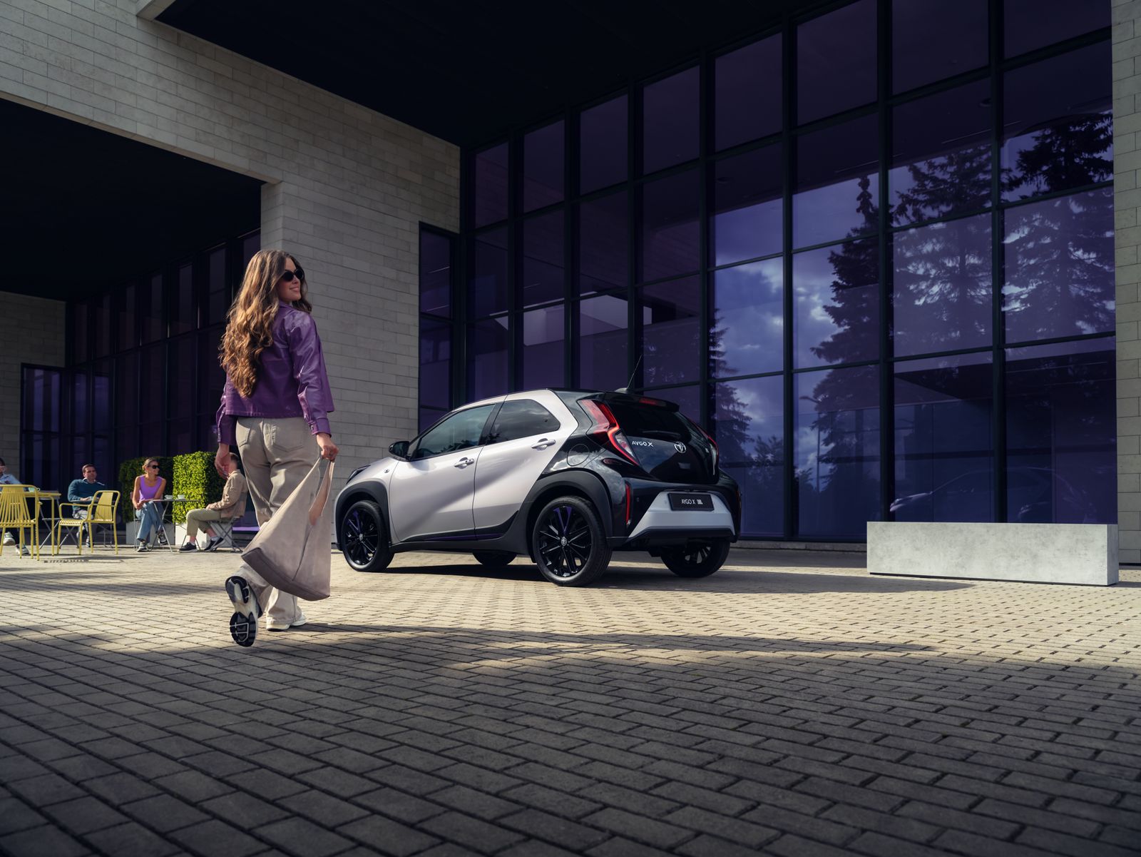 A Toyota Aygo X parked on city road