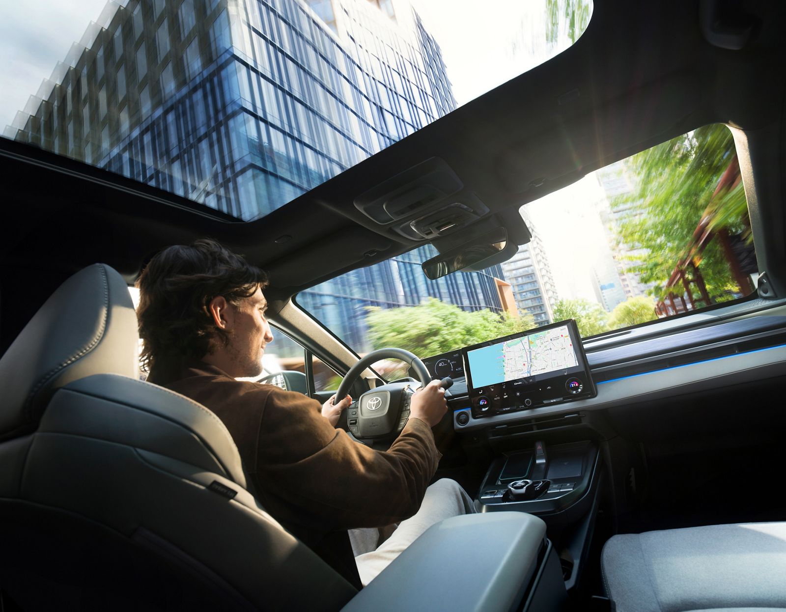 TOYOTA C-HR+ driver enjoying driving in the city