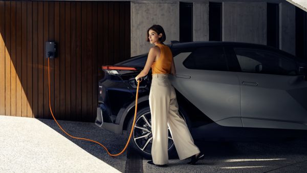 Woman charging Toyota C-HR Plug-in