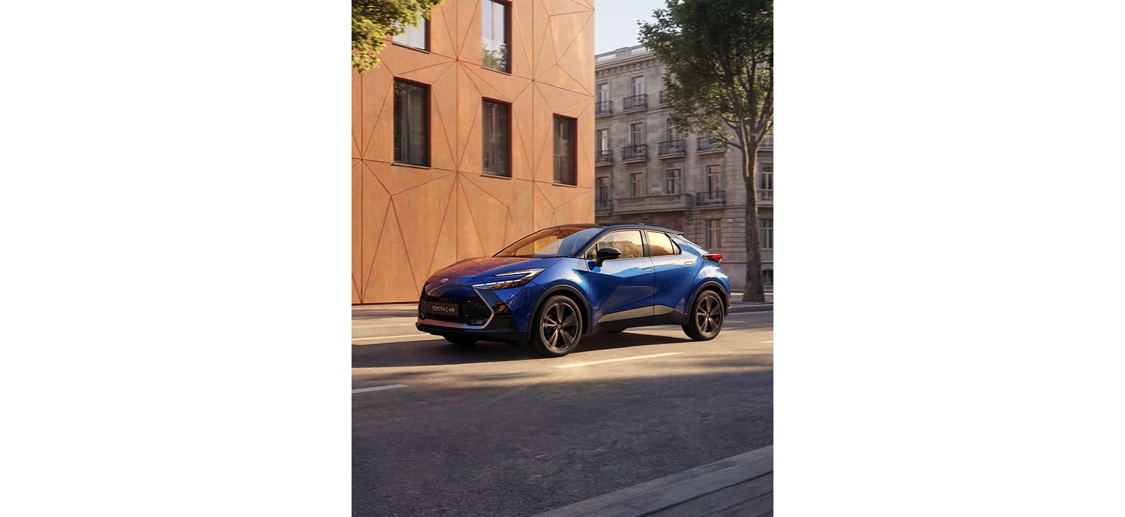 Ein blauer Toyota C-HR fährt durch eine Stadtstraße vorbei an moderner urbaner Architektur.