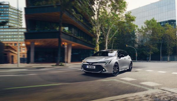 Toyota Yaris with a woman walking past