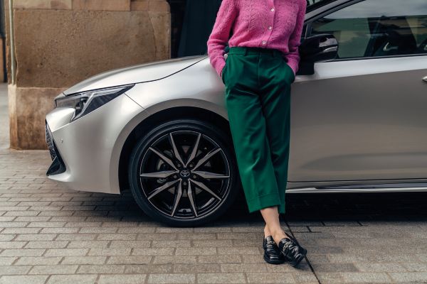 person leaning on a Toyota car