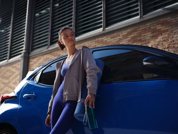 Woman leaning on Toyota Yaris