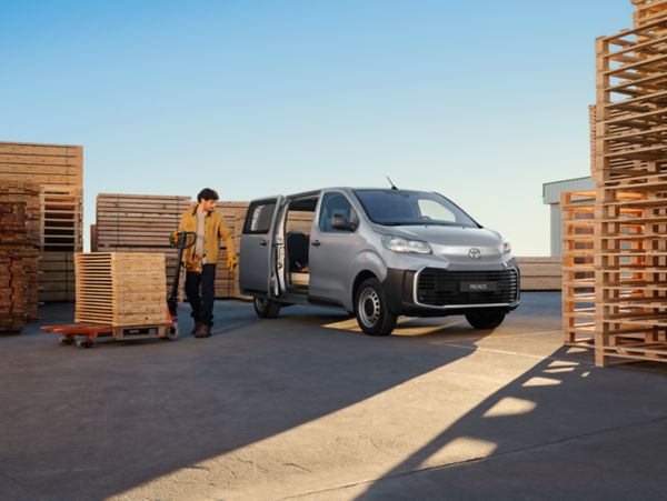 person standing next to a Toyota Proace