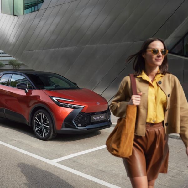 Woman walking past Toyota C-HR