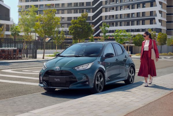 woman standing next to a Corolla Touring Sport