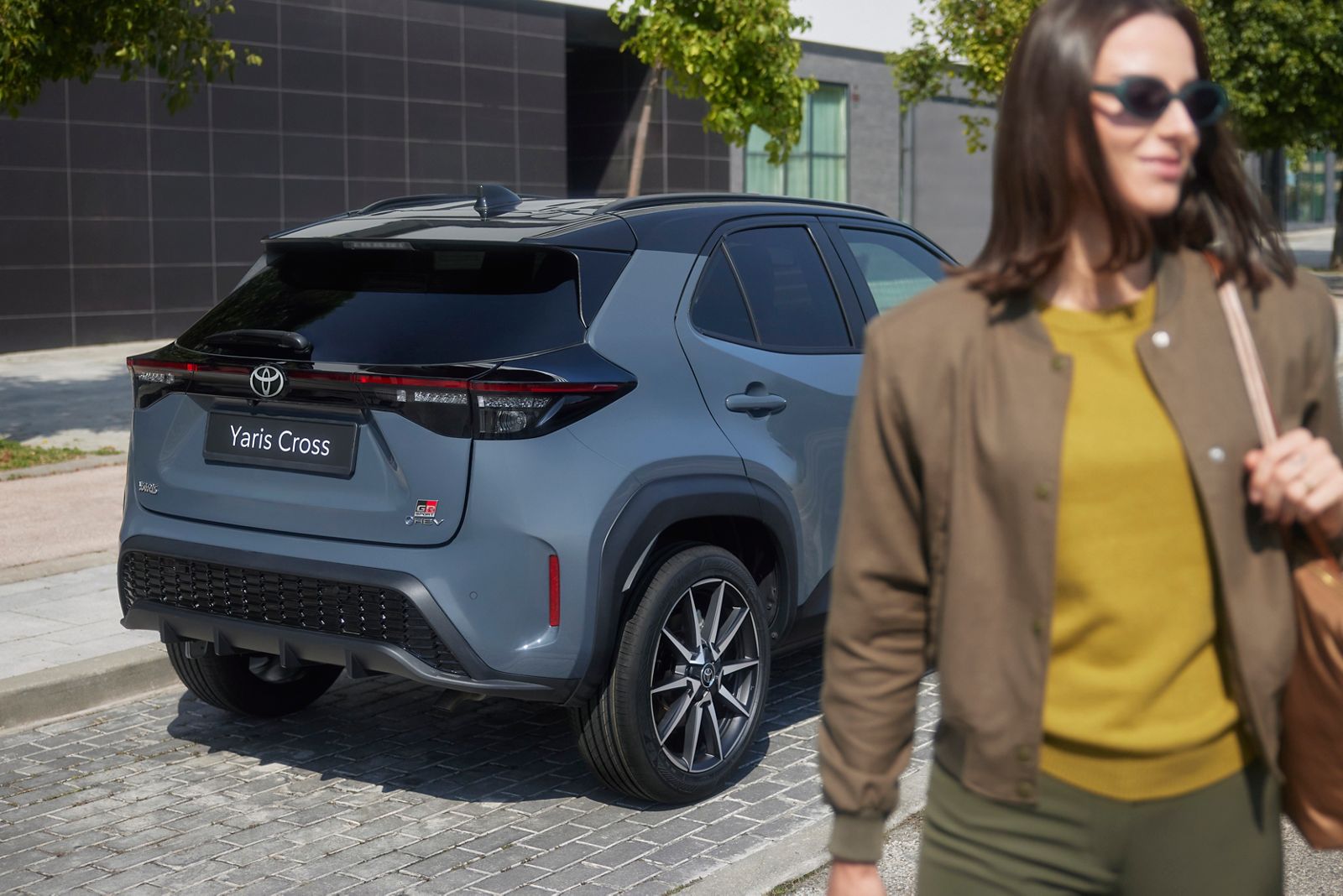Woman leaning against Yaris Cross