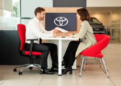 An owner discusses finance and insurance options with their Toyota dealer 