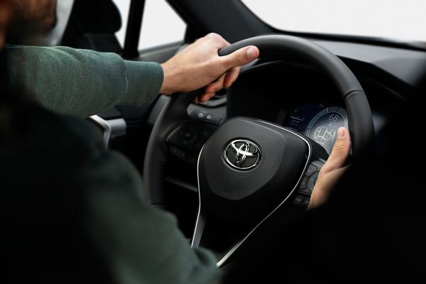 person driving a Toyota car