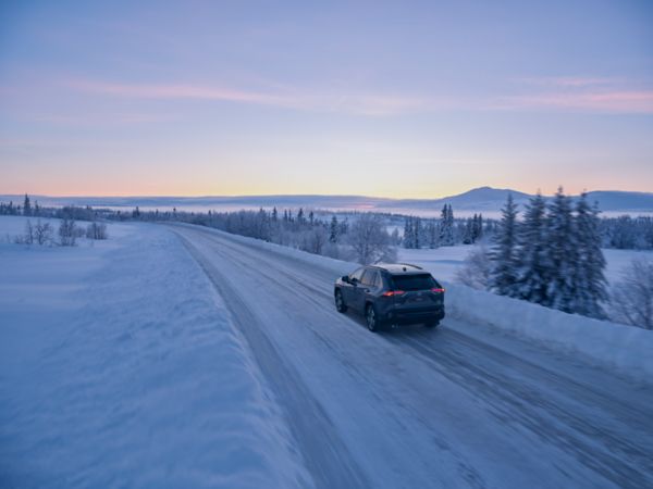 A customer pre-conditioning their car’s cabin temperature using the MyToyota app from outside the car