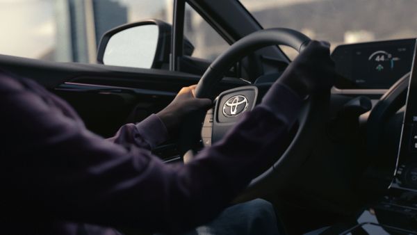 Driver holds hands on wheel