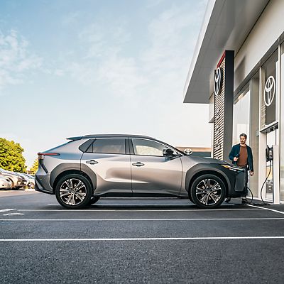 person walking towards their Toyota bZ4X