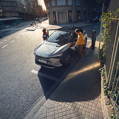 people entering a charging Toyota bZ4X