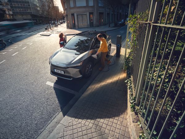 people entering a charging Toyota bZ4X