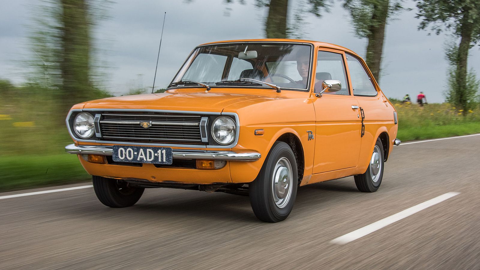 Toyota 1000, exterieur, linksvoor, oranje, rijdend