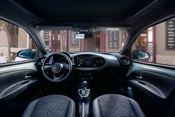 Image showing the dashboard and steering wheel of Tarragon Green  Aygo X