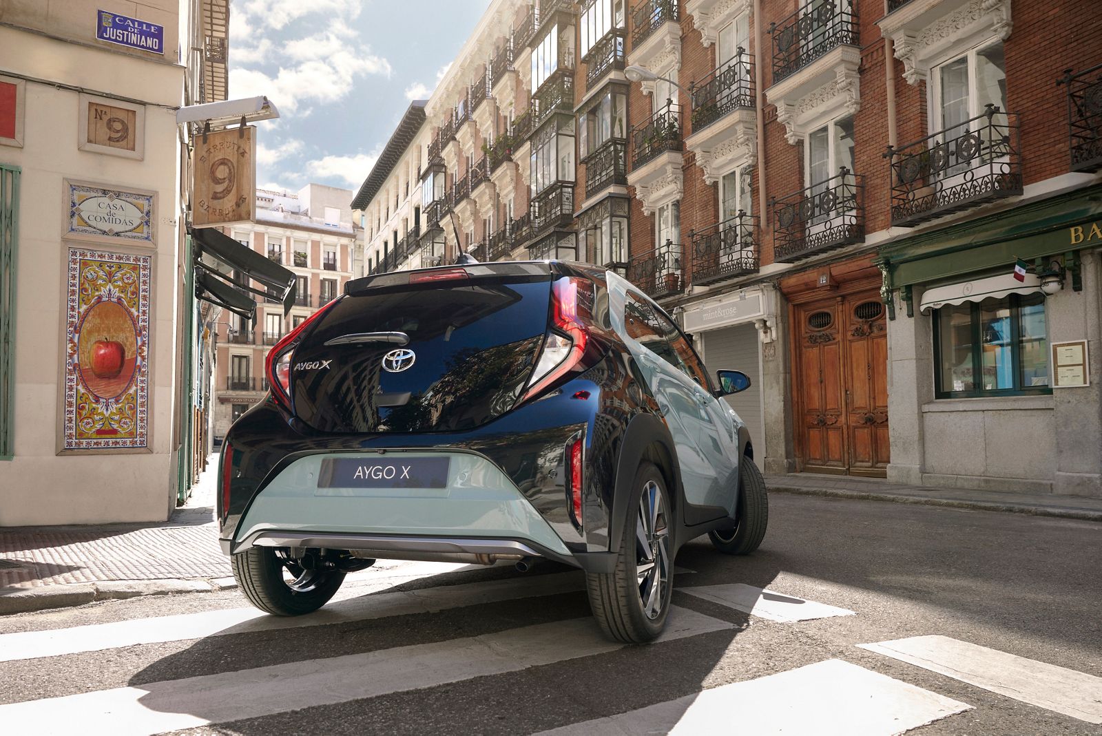 A woman enjoying driving a Aygo X