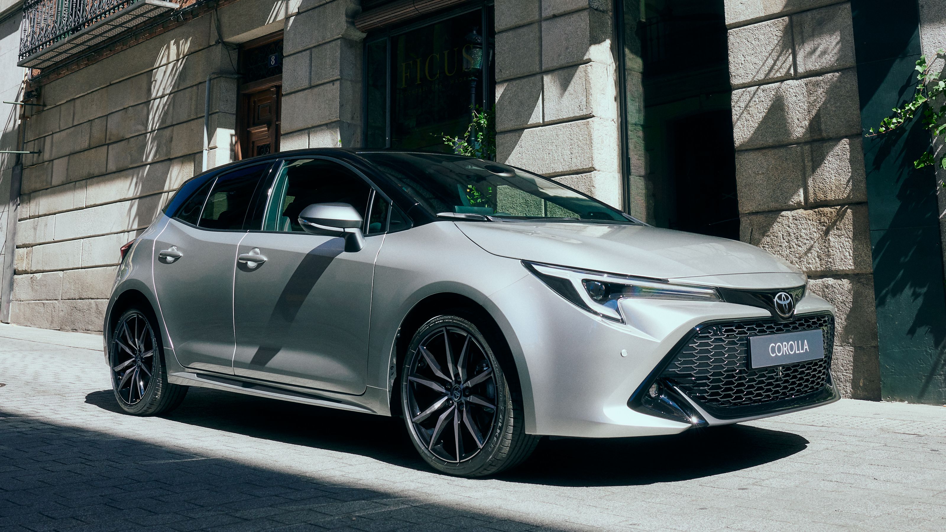 People approaching Toyota Corolla Hatchback