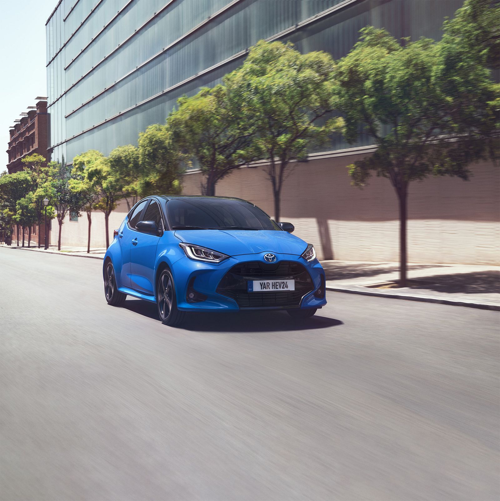 Woman leaning on a wall, looking happy