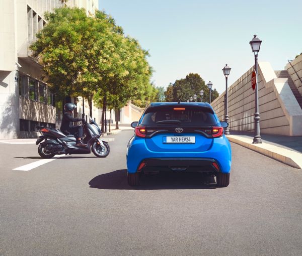 person running past a Toyota Yaris