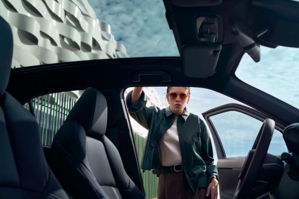 A Yaris Cross customer opening the door of the car, exploring the roomy interior