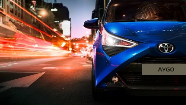 Toyota Aygo driving on city road at night