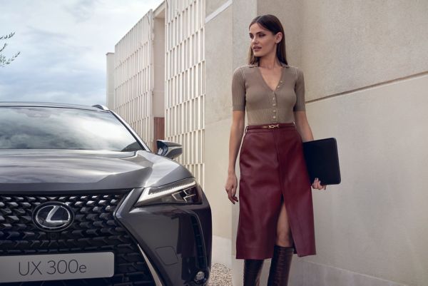 Woman walking by Lexus car