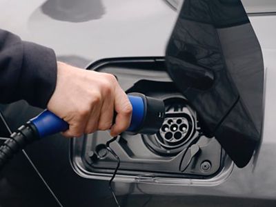 Recharge d’un véhicule électrique Toyota avec câble branché sur la prise de charge.