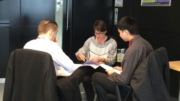 Toyota community volunteers around a table talking