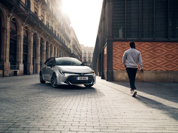 Man approaching Toyota Corolla Hatchback