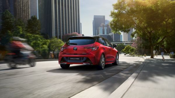 Toyota Corolla Hybrid driving down a road