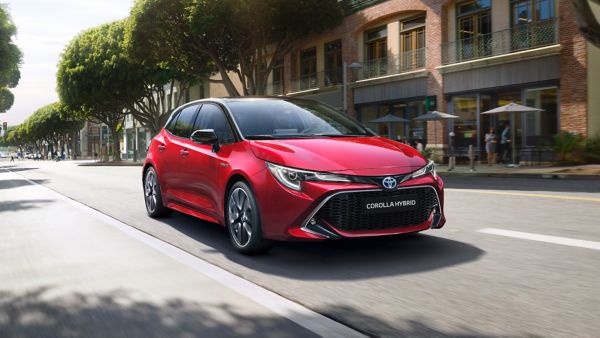 Toyota Corolla Hybrid driving down a road