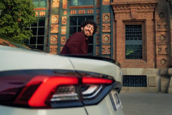 person leaning on a Toyota car
