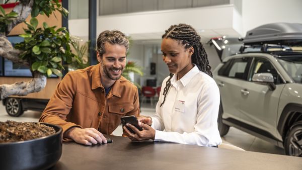 Consultant offering advice about Toyota at dealership