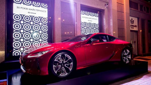 Lexus LC and LC Convertible parked in front of a racetrack 