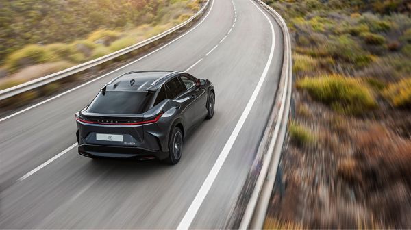 Rear view of the Lexus RZ 450e driving