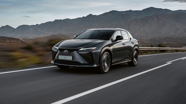 Side view of the Lexus RZ driving in a rural environment 