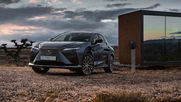 Lexus RZ plugged into a charging tower