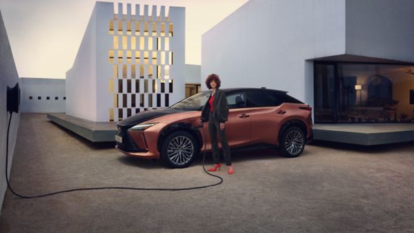 Person charging a Lexus RZ 450e car