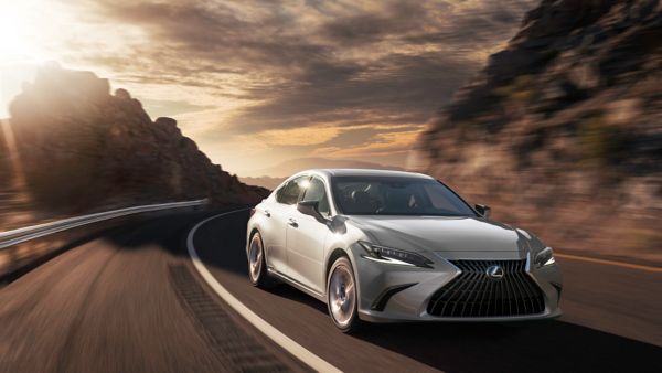 A black Lexus ES 300h driving on a road