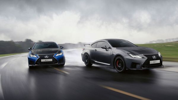 Lexus LC and LC Convertible parked in front of a racetrack 