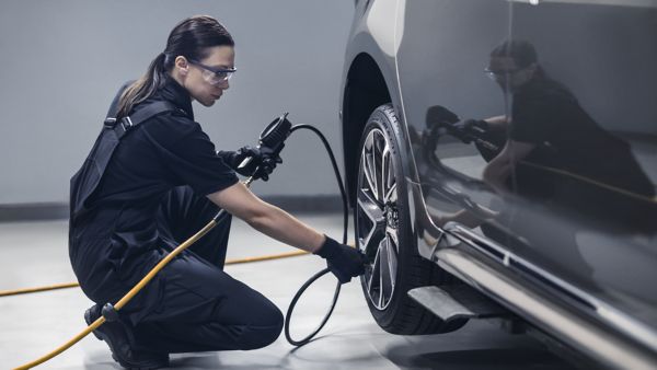 Female technician inflating tyre