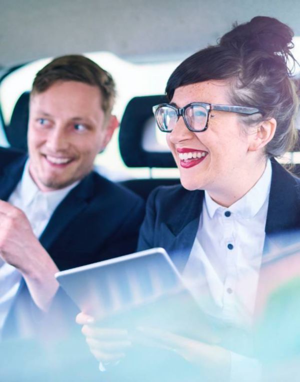 Kinto car share, 2 people happy in the back seat laughing