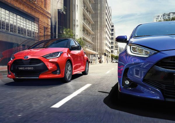 Toyota Yaris hybrids driving along a road