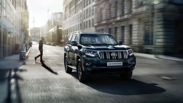 man walking towards Toyota Land Cruiser